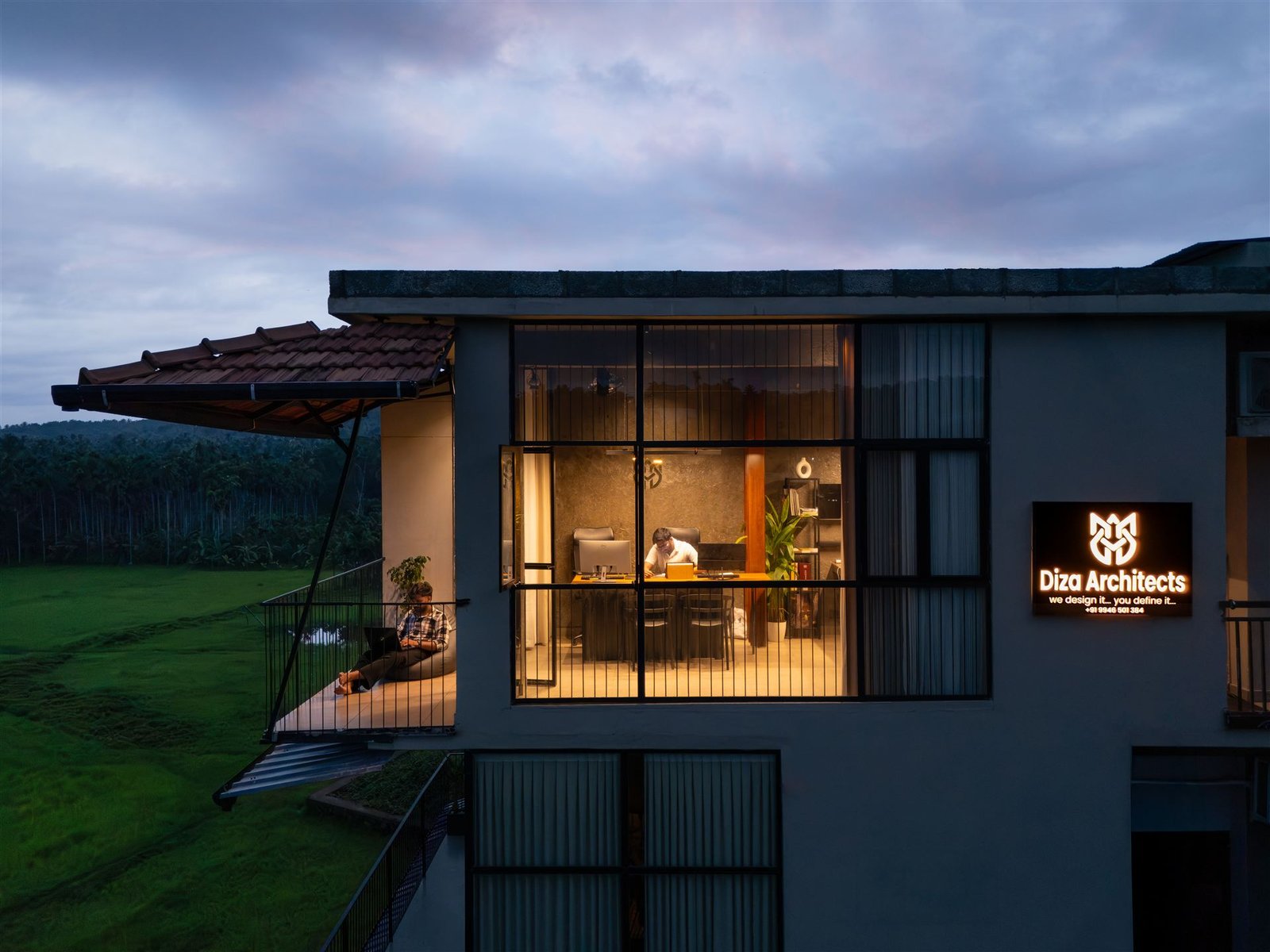 The DIZA Architects office at dusk with its sign glowing